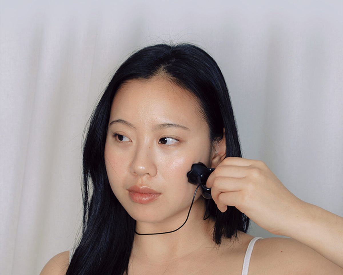 Woman using the Face Sculpt Ring
