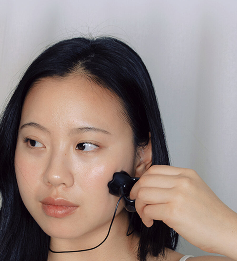Woman using the Face Sculpt Ring